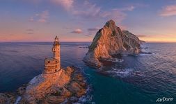 Lighthouse and Cape Aniva at sunrise